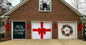 House with Christmas garage decor: text, gift wrap, wreath.