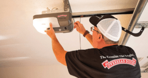 Technician fixing a garage door opener.